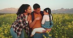 Mom, dad and child in field of flowers playing, having fun and laugh together on countryside holiday. Spring, adventure and loving family enjoy outdoor nature. Love, affection and parents with girl