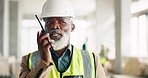 Senior engineer, walkie talkie and black man at construction site talking, speaking or working. Communication, radio tech and elderly architect from Nigeria in discussion or chat on building project
