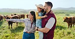 Farm, cattle and family on holiday in the countryside of Argentina for a sustainable lifestyle in summer. Mother, father and kid on the grass of a field for animal cows during a vacation in nature