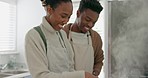 Love, health and black couple cooking food for their healthy vegan diet for energy and nutrition in a house kitchen. Smile, African and happy woman prepares organic vegetables for dinner with partner