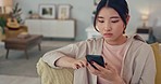 Woman, phone and social media or social network app typing, scroll and internet news at home. Asian girl online texting message on mobile smartphone or cellphone connected to house 5g wifi on couch
