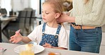 Hair care, brush and kid with mother talking, play and relax in home kitchen during morning breakfast. Mom prepare for day, bonding time and child care for happy family youth girl with mama's love