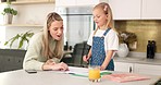 Education, mother and girl writing in kitchen for school task, assignment or homework. Help, learning and mom with child teaching, explaining or helping kid in home in the morning with books on table