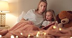 Story, book and reading mother with child in bedroom for child education, home learning or language development together. Mom and girl kid with creative literature for kindergarten with lamp lights