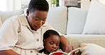 Book, reading and black family mother with child in living room for creative development, story time and home learning. Care, love and mom teaching literature in lounge with african kid listening