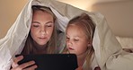 Tablet, mother and girl with bedroom blanket fort at night in house on education website, learning or study game. Woman, child and digital technology in family home for internet ebook bedtime bonding