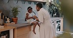 Family, children and love with a girl and mother playing together in the kitchen of their home. Kids, funny and tickline with a black woman and daughter laughing while bonding in their house