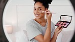 Makeup, live streaming and influencer black woman with light led for face beauty tips, advice and review cosmetic product in her bedroom. Gen z artist girl cosmetics filming online video tutorial