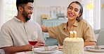 Couple, birthday and cake with kiss, blowing candles and hug, smile and clapping at a party in home. Happy latino man and woman with celebration, surprise and gift with romance, love and happiness