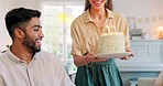 Birthday, cake and couple kiss with celebration, surprise and gift from wife to her husband with love in home. Man and woman celebrating, party and happy together with a present, snack or dessert