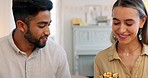 Gift, dinner and couple talking about birthday, anniversary or celebration at a dining room table in house. Happy, smile and young man and woman speaking about present, gratitude and love with food