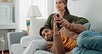 Relax, love and watching tv with couple on sofa for movie, streaming or television subscription. Happy, smile and peace with man on woman legs in living room at home for video, news or film together