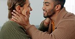 Love, support and happy with a couple in their home together, sharing an intimate moment with a kiss. Smile, talking and romance with a young man and woman kissing on a sofa in the living room