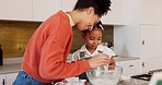 Family, children and baking with a woman and girl cooking in the kitchen of their home together. Food, taste and love with a mother and daughter adding ingredients to a bowl while preparing a dessert