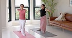 Yoga, stretching and teacher woman with client in studio home for wellness, balance and cardio fitness training. Pilates workout, body exercise and healthy women learning, accountability and support