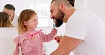 Dental health, father and girl for brushing teeth, together or laugh in bathroom in home to have fun. Oral hygiene, dad and daughter with tooth brush, being happy or bonding for happiness or in house