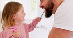 Happy family, dental and brushing teeth with girl and father in bathroom for hygiene, learning and grooming. Love, teeth and oral care by parent with daughter play, laugh and cleaning in their home