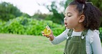 Girl kids blowing bubbles in park, garden and backyard, nature and environment of fun, joy and happy childhood development, growth and relax. Young child playing with soap bubbles in outdoor sunshine