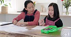 Child, homework and learning school work at tablet in family home with mother, grandmother or tutor for education, development and knowledge. Asian woman helping girl kid with studying in China home