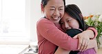 Happy, love and mother hugging her child with smile, bond and care in their family home. Happiness, bonding and Asian mom embracing her girl kid with loving, caring and tender hug at a house in Asia.
