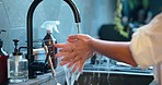 Woman, washing hands or bacteria cleaning in home bathroom, kitchen sink or house tap. Zoom on person, water or skincare healthcare disinfection before cooking for germs safety, security and wellness