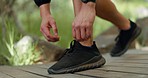 Fitness, park and man tie shoe for running, walking and training in nature. Exercise, workout and guy taking a walk on trail, tying laces of sneakers, doing sports for wellness, health and cardio