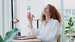 Woman in office, thinking and writing idea for creative startup business or schedule planning in notebook at desk. Freelance worker, designer or writer, pen in hand working on ideas in modern office.