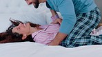Playful, comic and happy couple jump on bed, smile and love together in morning in a house. Excited, playing and funny man and woman with energy, being goofy and young with happiness in the bedroom