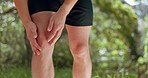 Knee pain, legs and park runner man, athlete and training, workout and exercise on outdoor nature trail. Closeup fitness body, inflammation problem and muscle injury, health risk and running sports