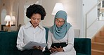 Tablet, teamwork and meeting with a muslim business woman talking to a colleague in the office. Islam, internet and collaboration with a black woman working with a female employee on a sofa at work