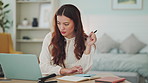 Laptop, calculator and woman doing home accounting of finance bills, taxes or mortgage financial payment. Young girl with digital data calculating savings budget, tax return or insurance loan balance