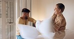 Pillow fight, playful and couple on the bed in a house for love, smile and happiness together. Comic, funny and young man and woman playing, being crazy and happy with a pillow in the bedroom