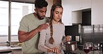 Love, couple and cooking food taste test of happy partner in home kitchen for romantic lunch date. Happiness, house and interracial people dating talk and smile while preparing meal with wine.