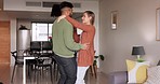 Love, dancing and young couple in living room having fun, bonding and happy together. Romance, multicultural relationship and Indian man and woman dance to music in apartment to relax on weekend