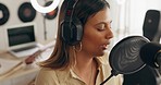 Recording, singer and artist with microphone in home studio singing, produce and create a song. Creative, musician and happy young woman with headphones in studio working on music, audio and track