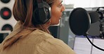 Guitar, singing and woman recording in a studio with a microphone, headphones and technology. Instrument, musician and girl singer or artist from Brazil playing music in a production room for a album