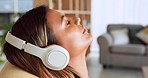 Woman face, relax and music headphones, living room sofa and wellness, peace and freedom of easy lifestyle. Mindfulness, meditation and young girl listening to radio, audio and dream podcast in home