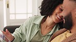 Tablet, love and relax with a black couple doing an online search while sitting on the sofa of their home together. Social media, scrolling and internet with a man and woman relaxing in a living room