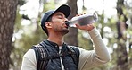 Hike, drinking water and man on a nature walk doing outdoor fitness, exercise and training. Walking, sport and cardio workout of a athlete person from Spain outdoors for wellness, health and sports