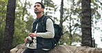 Hiking, water and adventure with a man drinking from a bottle in the forest or woods in nature. Fitness, exercise and hike with a male athlete hiking amongst the trees for a hobby or recreation