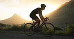 Bicycle, mountain and man cycling on road with sunrise, summer and nature landscape. Inspiration, wellness and motivation in sports, cyclist riding a bike in morning for fitness, workout and exercise