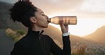 Black woman, athlete and drinking water for wellness, fitness and after running outdoor endurance, workout and hydration. Exercise, female runner and girl thirsty, break and rest in nature for health