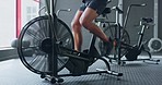 Stationary bicycle, spinning and fitness workout of a woman busy with exercise and gym training. Sport, health and wellness cardio of a athlete working out on a bike at a health club and studio