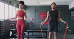 Jump, rope and couple training for fitness, workout and energy for body motivation at the gym. Fast, power and man and woman with energy for skipping exercise, wellness and cardio together at a club