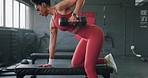 Weightlifting, black woman and weight in a gym for arm strength and muscular endurance while listening to music. Dumbbell, fitness and strong african weightlifter working out for health and wellness 