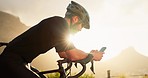 Mountain bike, phone and bicycle man in nature with 5g network, mobile app or social media update in sunshine lens flare. Travel cyclist on rock for cycling goal with location check on smartphone