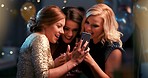 Young caucasian female friends talking laughing using phone at party