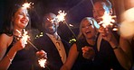 Young diverse friend group happy smiling holding sparkler at party