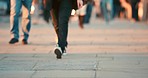 Blurred closeup of the feet of people walking through the city