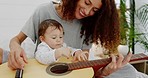 Mother and baby playing guitar for fun, learning and music,, creative development growth in living room in family home. Mom teaching child with acoustic instrument for joy, sounds and musical art 